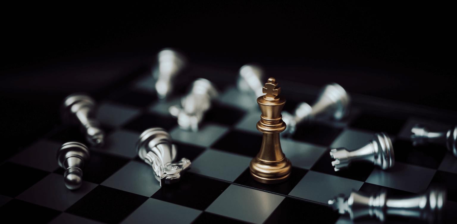 The Secret to finding the best candidate - silver chess pieces lying around one standing gold piece