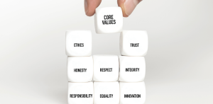 Building a Culture of Hard Work - stacked dice with different work values written on them, the main one being 'Core Values'