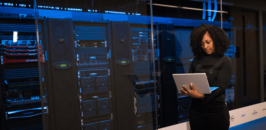 Woman using her laptop and standing new computer servers